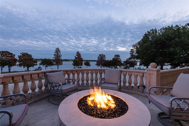 view of patio / terrace featuring a water view and an outdoor fire pit