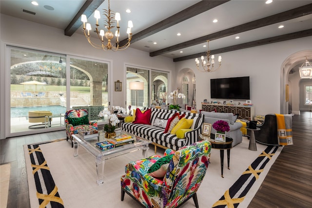 living room with a chandelier, hardwood / wood-style floors, and beamed ceiling