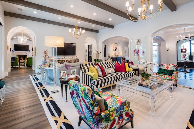 living room featuring beam ceiling, an inviting chandelier, and hardwood / wood-style flooring