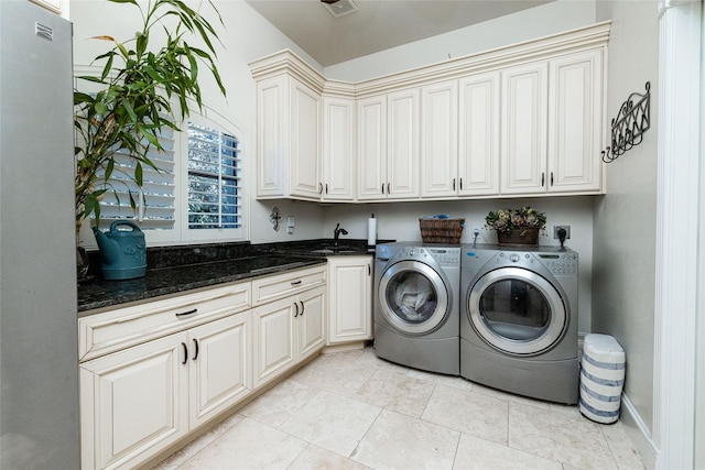 washroom featuring cabinets, light tile patterned floors, sink, and independent washer and dryer