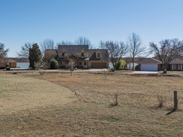 view of front of home featuring a garage and a front lawn