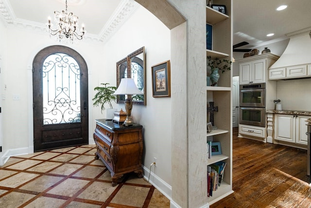 foyer entrance with dark hardwood / wood-style floors and a chandelier