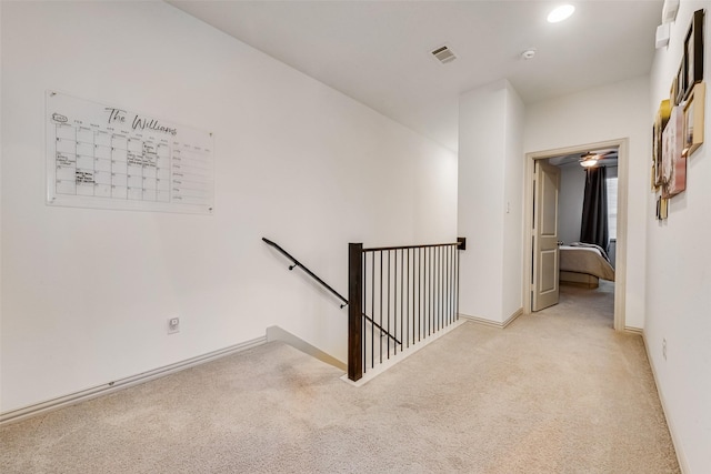 hall featuring light colored carpet