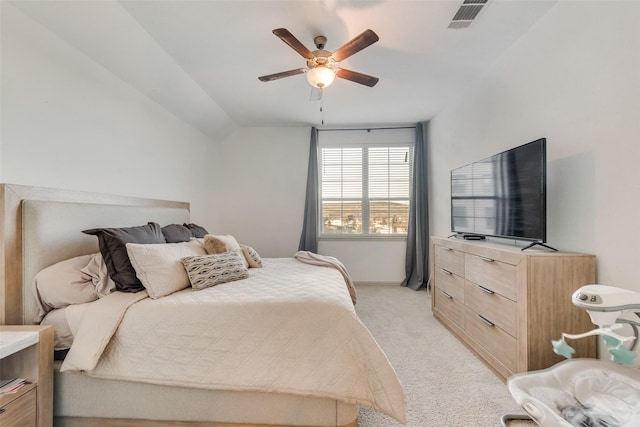 bedroom with ceiling fan, lofted ceiling, and light colored carpet