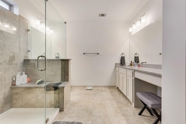 bathroom with a shower with shower door and vanity