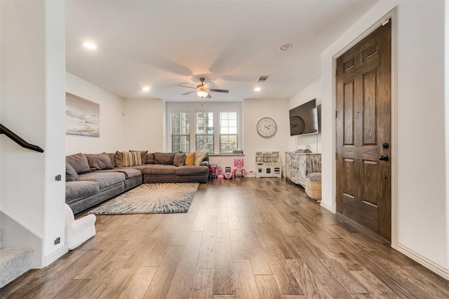 living room with ceiling fan and hardwood / wood-style flooring