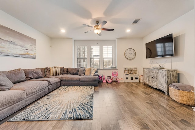 living room with ceiling fan and hardwood / wood-style floors