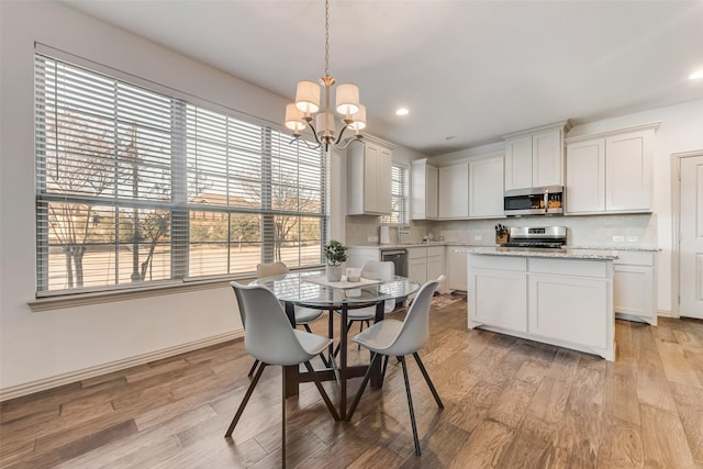 dining area featuring a chandelier and light hardwood / wood-style flooring