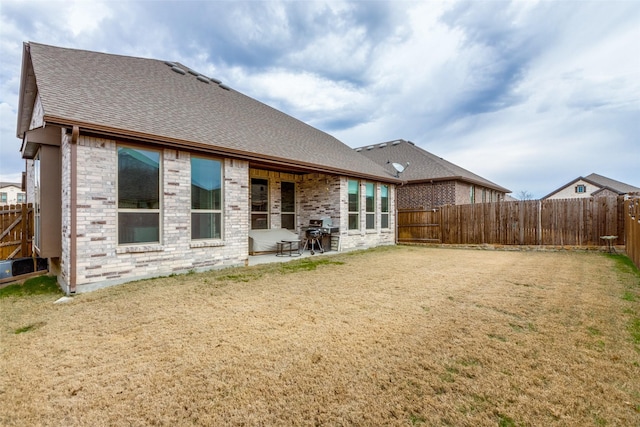 back of house featuring a lawn and a patio