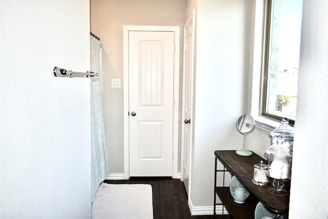 hallway featuring dark hardwood / wood-style floors