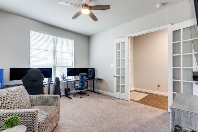 carpeted office space featuring ceiling fan and french doors