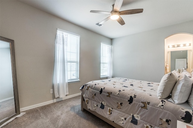 carpeted bedroom with ceiling fan and connected bathroom