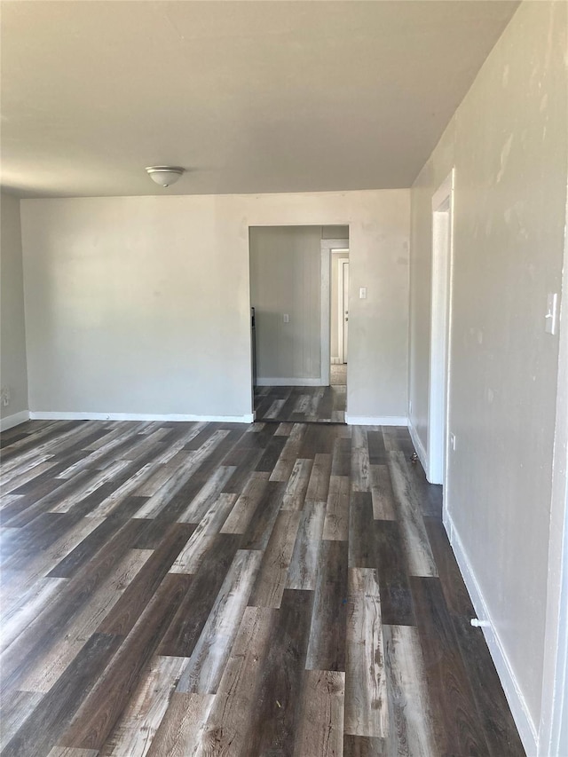 empty room featuring dark wood-type flooring