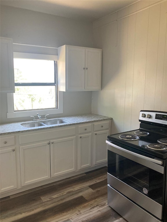 kitchen featuring white cabinetry, sink, dark hardwood / wood-style floors, and electric stove