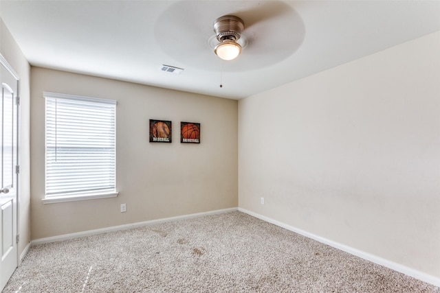 carpeted empty room featuring ceiling fan and a healthy amount of sunlight