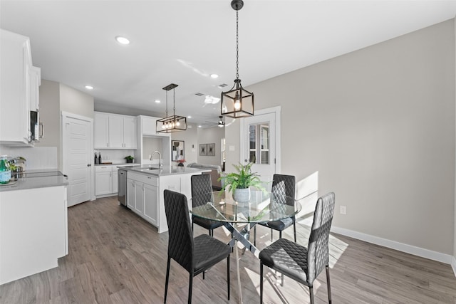 dining area featuring a ceiling fan, recessed lighting, baseboards, and wood finished floors