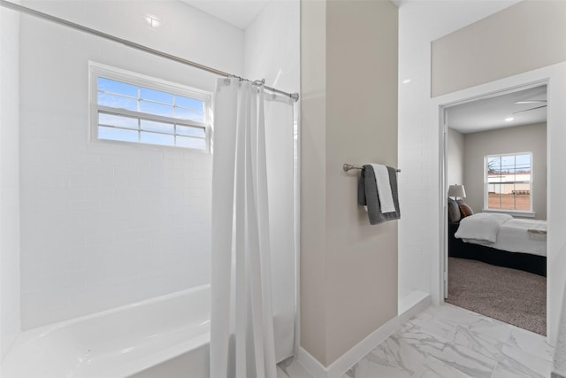 ensuite bathroom with marble finish floor, shower / bath combo, baseboards, and ensuite bathroom