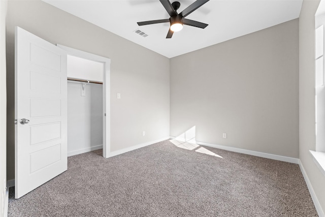 unfurnished bedroom featuring visible vents, baseboards, a ceiling fan, carpet, and a closet