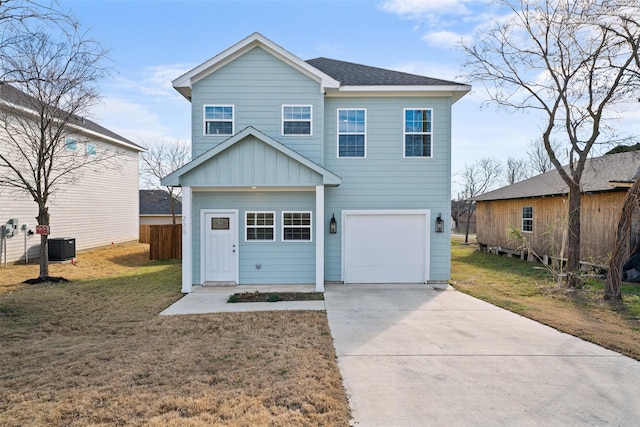 view of front of property with a garage, a front lawn, and central air condition unit