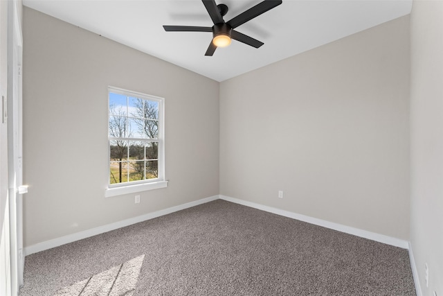 spare room featuring a ceiling fan, carpet, and baseboards