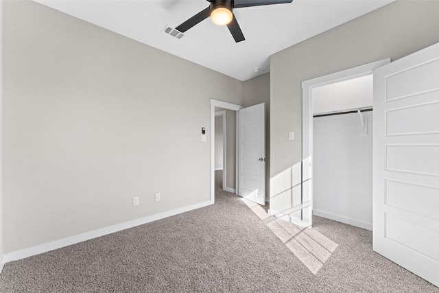 unfurnished bedroom featuring visible vents, baseboards, a closet, and light colored carpet