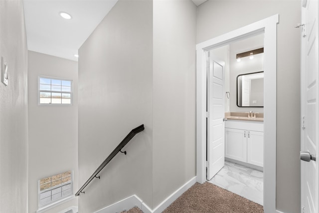 stairway with baseboards, marble finish floor, carpet floors, and recessed lighting