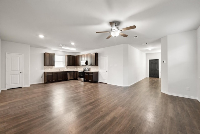 unfurnished living room with ceiling fan and dark wood-type flooring