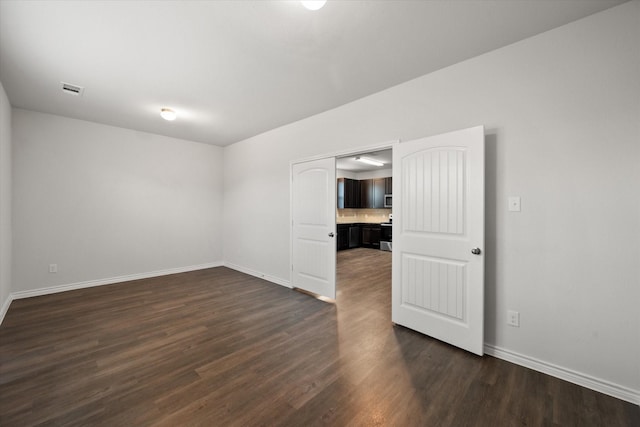 spare room with dark hardwood / wood-style flooring