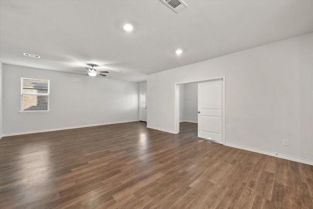 spare room featuring dark wood-type flooring and ceiling fan