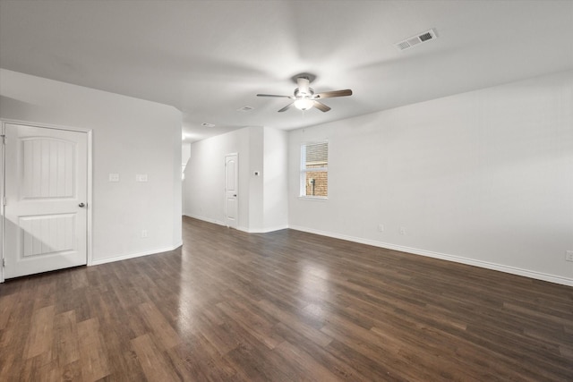 spare room featuring ceiling fan and dark wood-type flooring