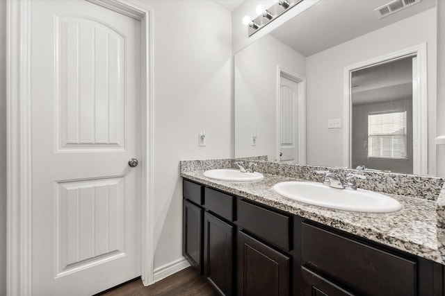 bathroom featuring vanity and hardwood / wood-style floors