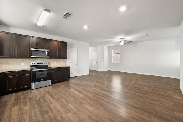 kitchen featuring stainless steel appliances, tasteful backsplash, dark hardwood / wood-style floors, ceiling fan, and dark brown cabinets