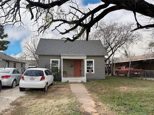 bungalow-style house with a front lawn