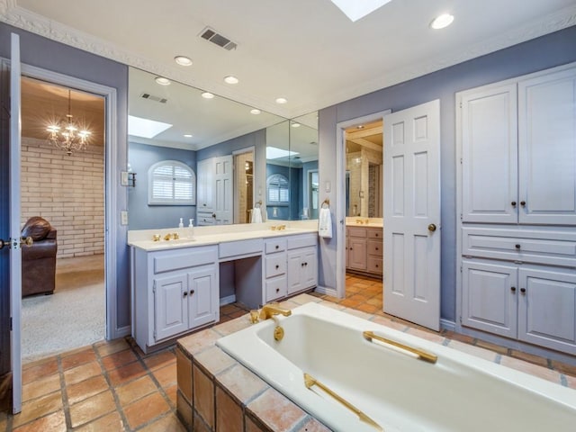 bathroom featuring a skylight, crown molding, and vanity