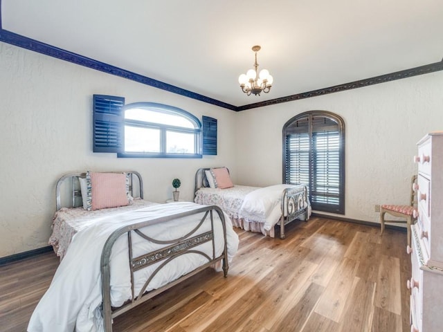 bedroom featuring hardwood / wood-style flooring and a notable chandelier