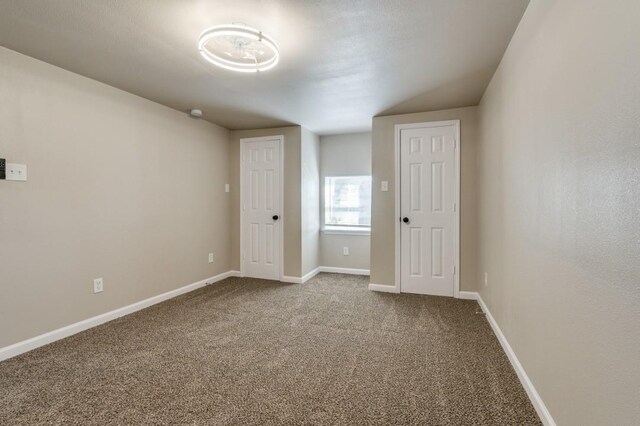 carpeted empty room featuring ceiling fan and plenty of natural light