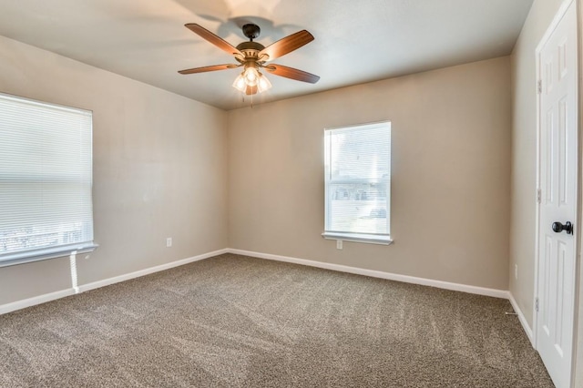 carpeted empty room featuring ceiling fan