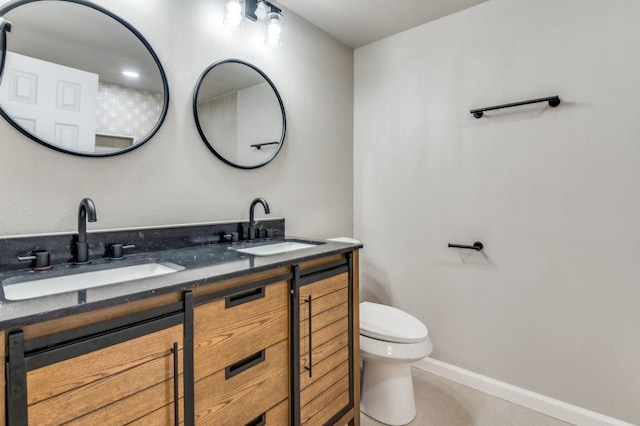 bathroom featuring tile patterned floors, vanity, and toilet