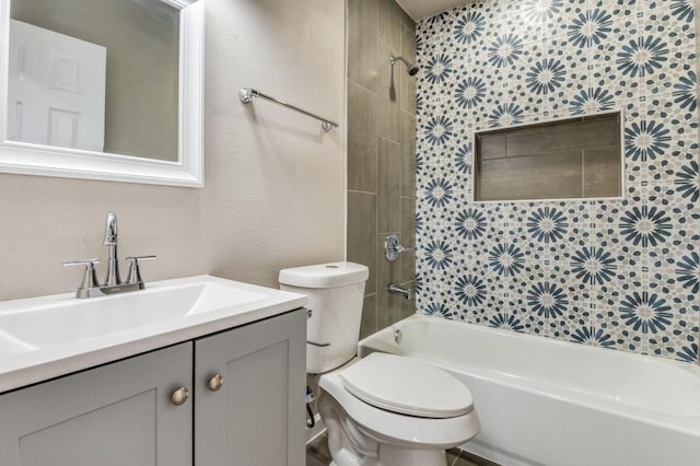 full bathroom with toilet, vanity, and tiled shower / bath combo