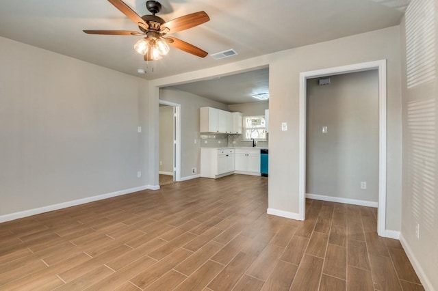 unfurnished living room featuring ceiling fan and light hardwood / wood-style floors