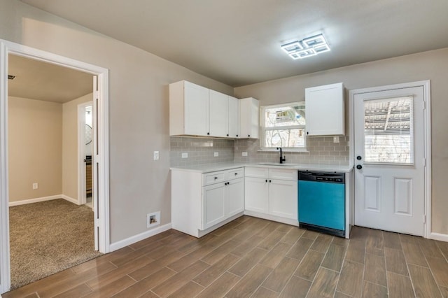 kitchen with decorative backsplash, sink, white cabinets, and dishwasher