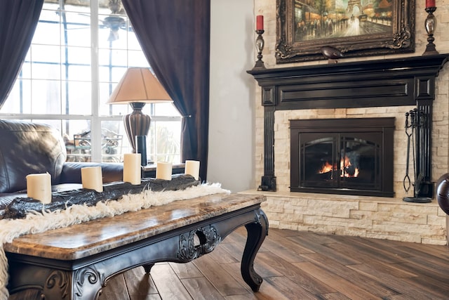 living area featuring plenty of natural light, a fireplace, and wood finished floors