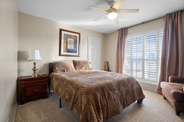 bedroom featuring light carpet and a ceiling fan