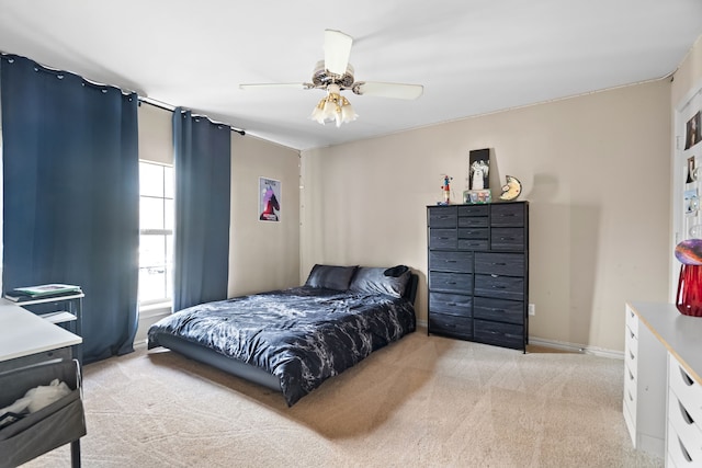 bedroom with baseboards, a ceiling fan, and light colored carpet