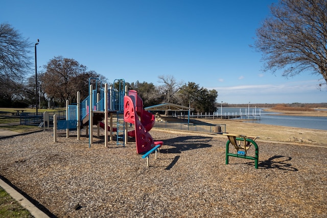 community playground with a water view and fence