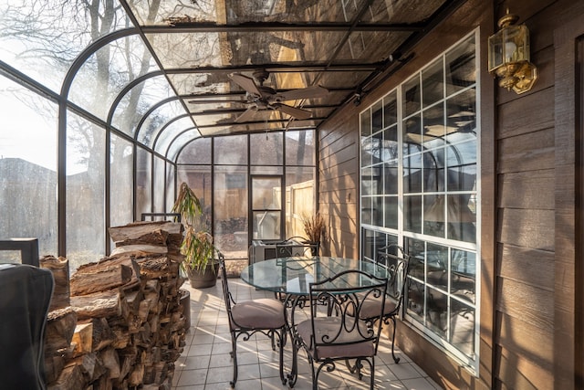 sunroom / solarium with ceiling fan and a mountain view