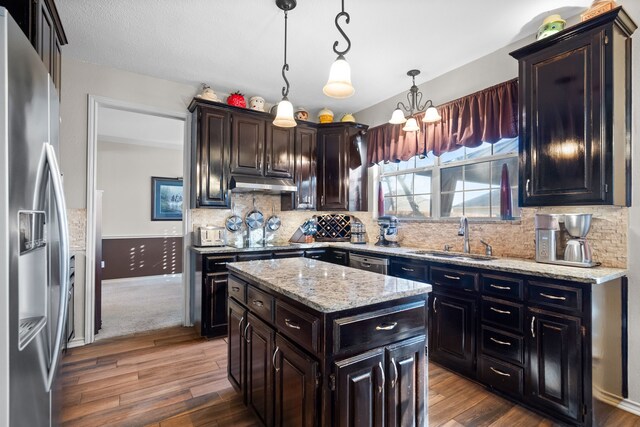 carpeted dining space featuring ornamental molding, a notable chandelier, and baseboards
