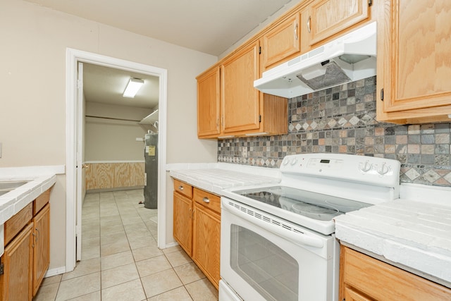 kitchen with light tile patterned floors, decorative backsplash, and electric stove