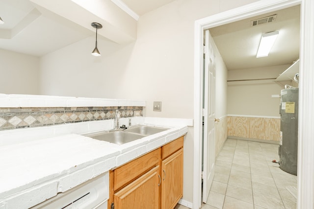 bathroom with water heater, tile patterned flooring, and sink