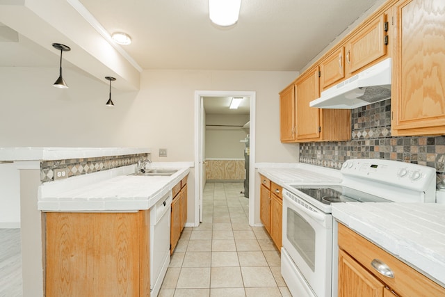 kitchen with tasteful backsplash, pendant lighting, sink, white appliances, and light tile patterned floors